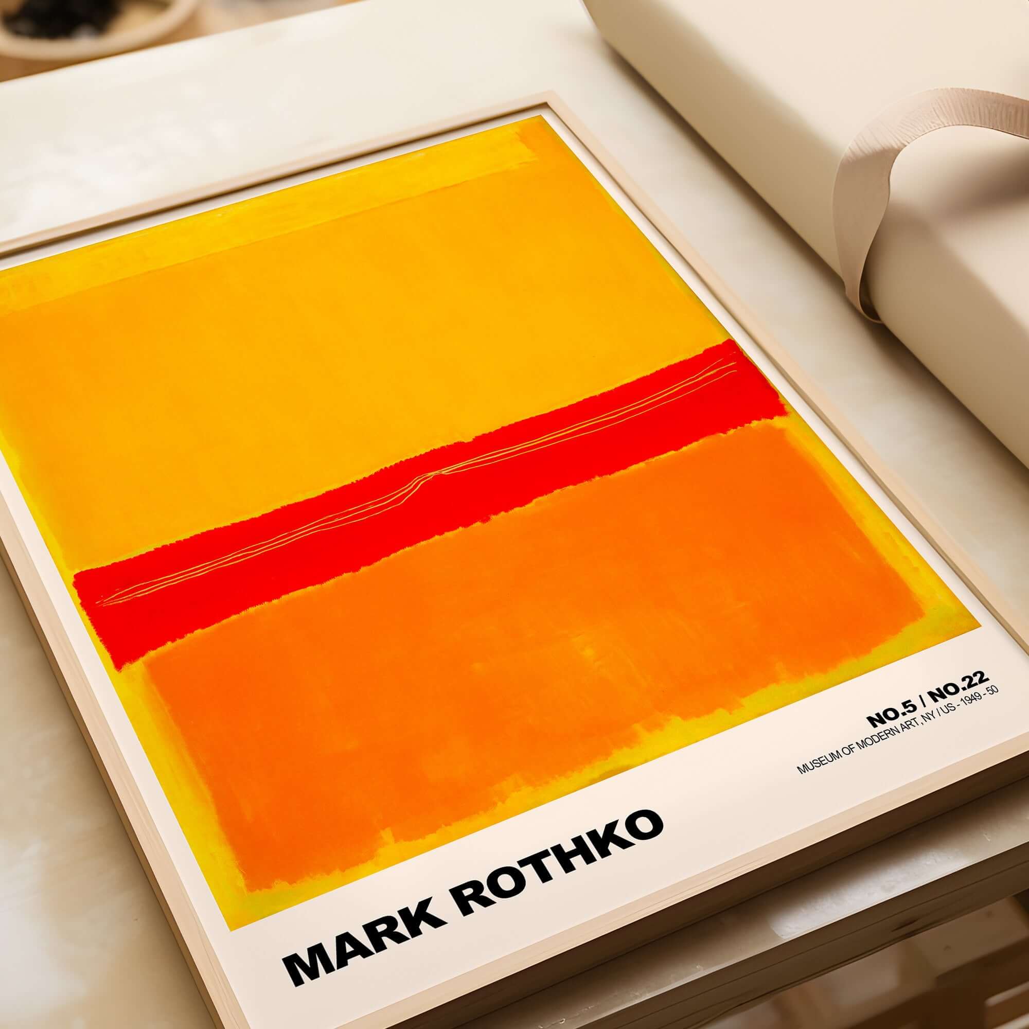 Mark Rothko No 5 No 22 Abstract Expressionist Print Red Orange Yellow Poster Wall Art displayed on a table.