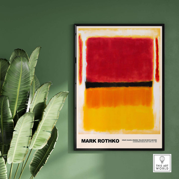 Mark Rothko 1949 abstract art print in vibrant orange, yellow, and red framed on a green wall with a plant.