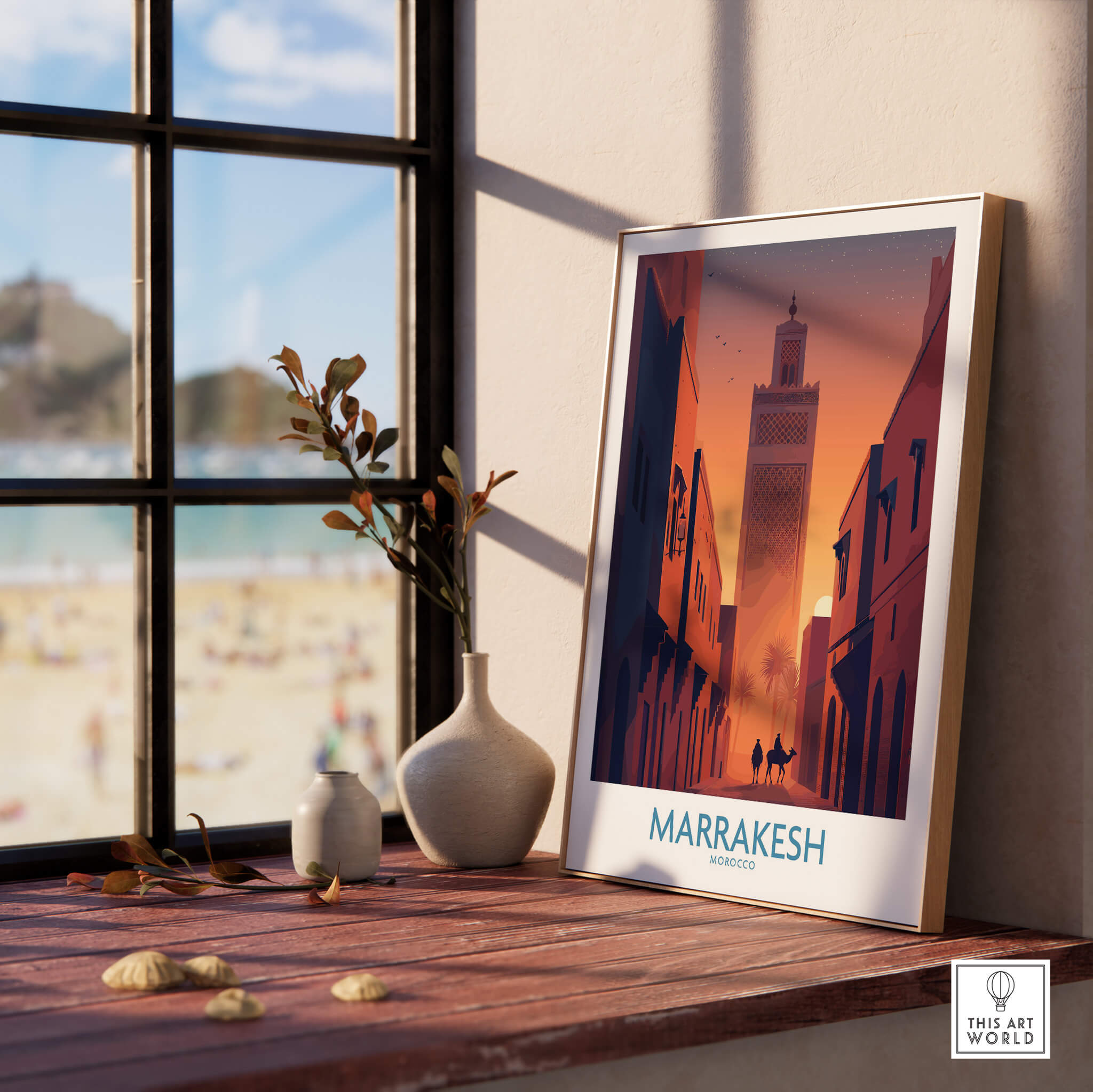 Marrakesh Morocco Canvas Print | Sunset Camels Poster displayed on a wooden table with a view of the beach.