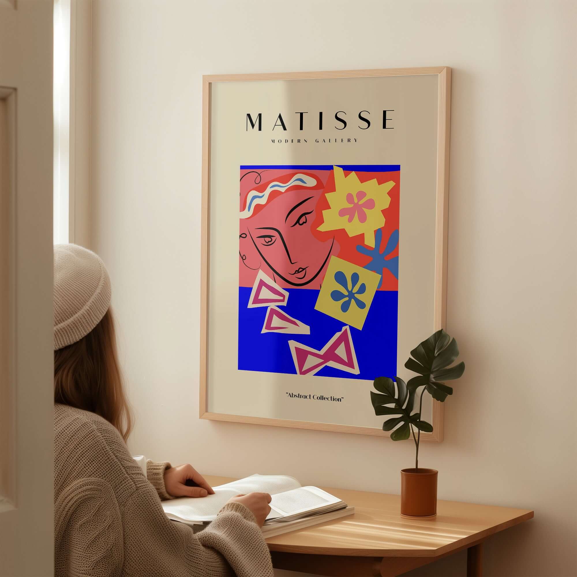 Matisse Art Prints - Abstract Face with Flowers Collage Wall Art displayed above a woman studying at a desk.