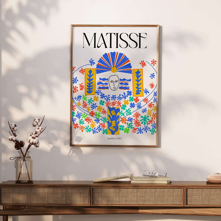 Matisse Apollon 1953 cut-out wall art print featuring colorful floral designs and a central mask on display.