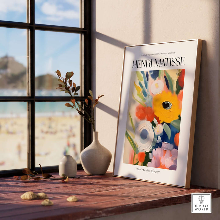 Matisse art print featuring bold abstract flowers, displayed on a sunlit windowsill with beach view.