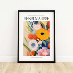 Matisse Art Prints - Abstract Flowers Poster featuring colorful floral artwork in a black frame on wooden flooring.