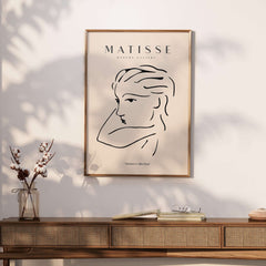 Matisse Art Prints - Abstract Line Drawing of Lady displayed in a stylish interior setting with framed art and decor.