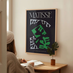 Matisse Art Print Composition Black Green White Abstract Poster 1947 displayed in a modern space with a woman studying.