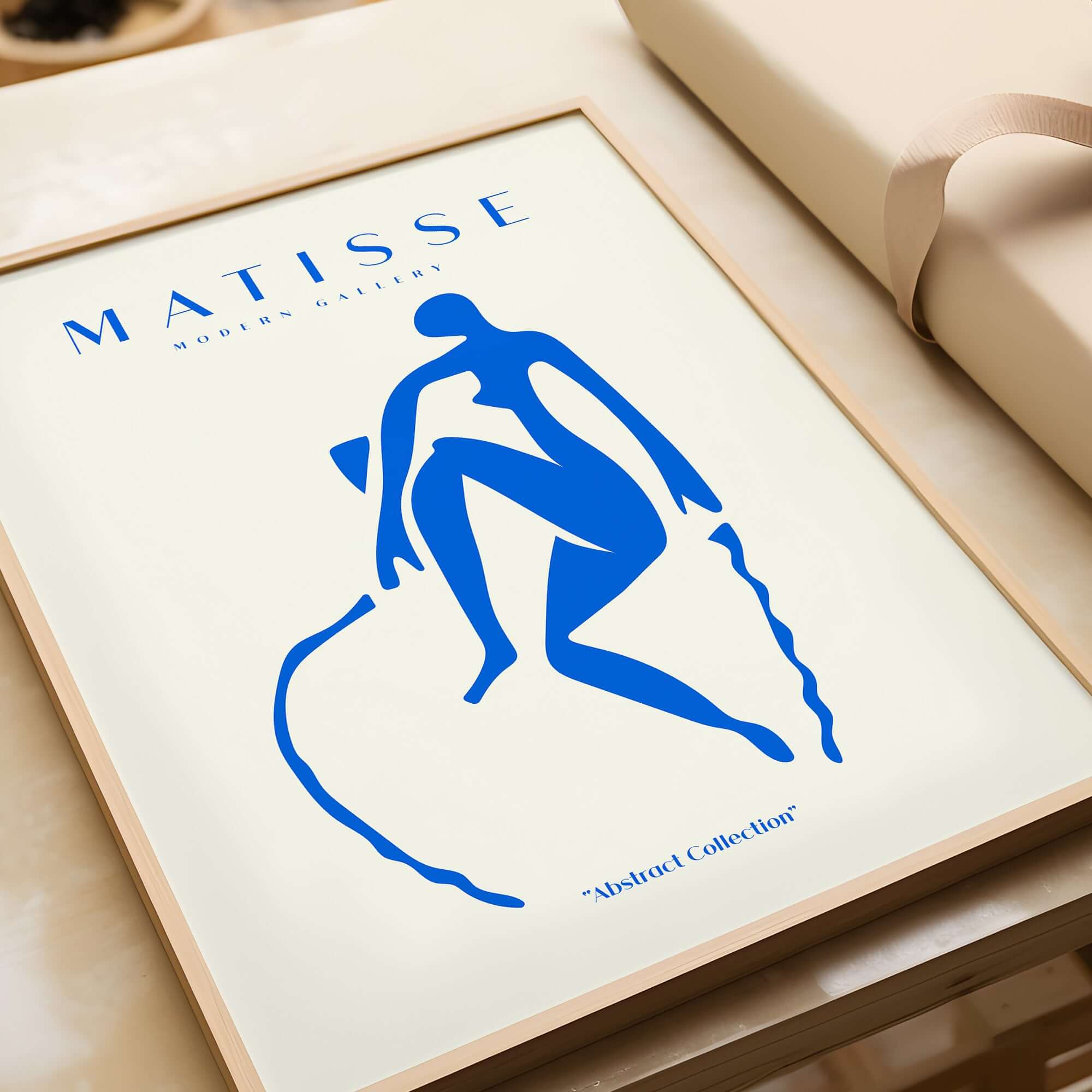 Matisse Art Prints -  Blue Nude Seated Figure Poster featuring a blue cut-out silhouette on beige background.