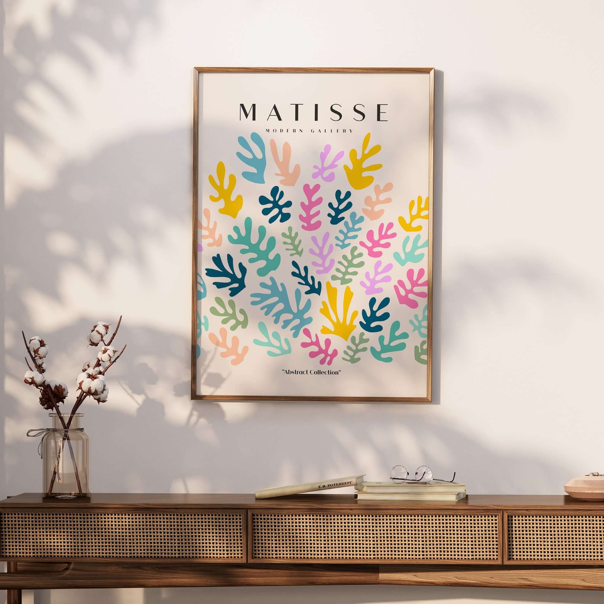 Matisse Art Prints - Colorful Abstract Botanical Scatter Poster displayed on a stylish wall behind a wooden table.