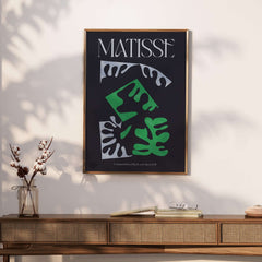 Matisse Art Print Composition Black Green White Abstract Poster 1947 framed on a wall, showcasing bold abstract shapes and colors.