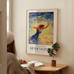 Matisse Art Prints - Dancing Figure Swirl Background Art Print displayed in a cozy setting with a person reading.