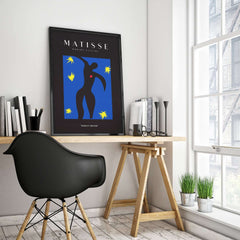 Matisse Art Prints - Icarus Black Figure with Stars Poster displayed in a modern workspace, featuring vibrant colors and artistic design.