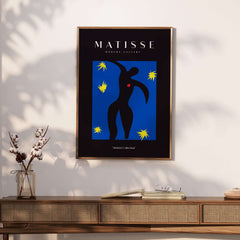 Matisse Art Prints - Icarus Black Figure with Stars Poster displayed on a wall with a modern wood console.