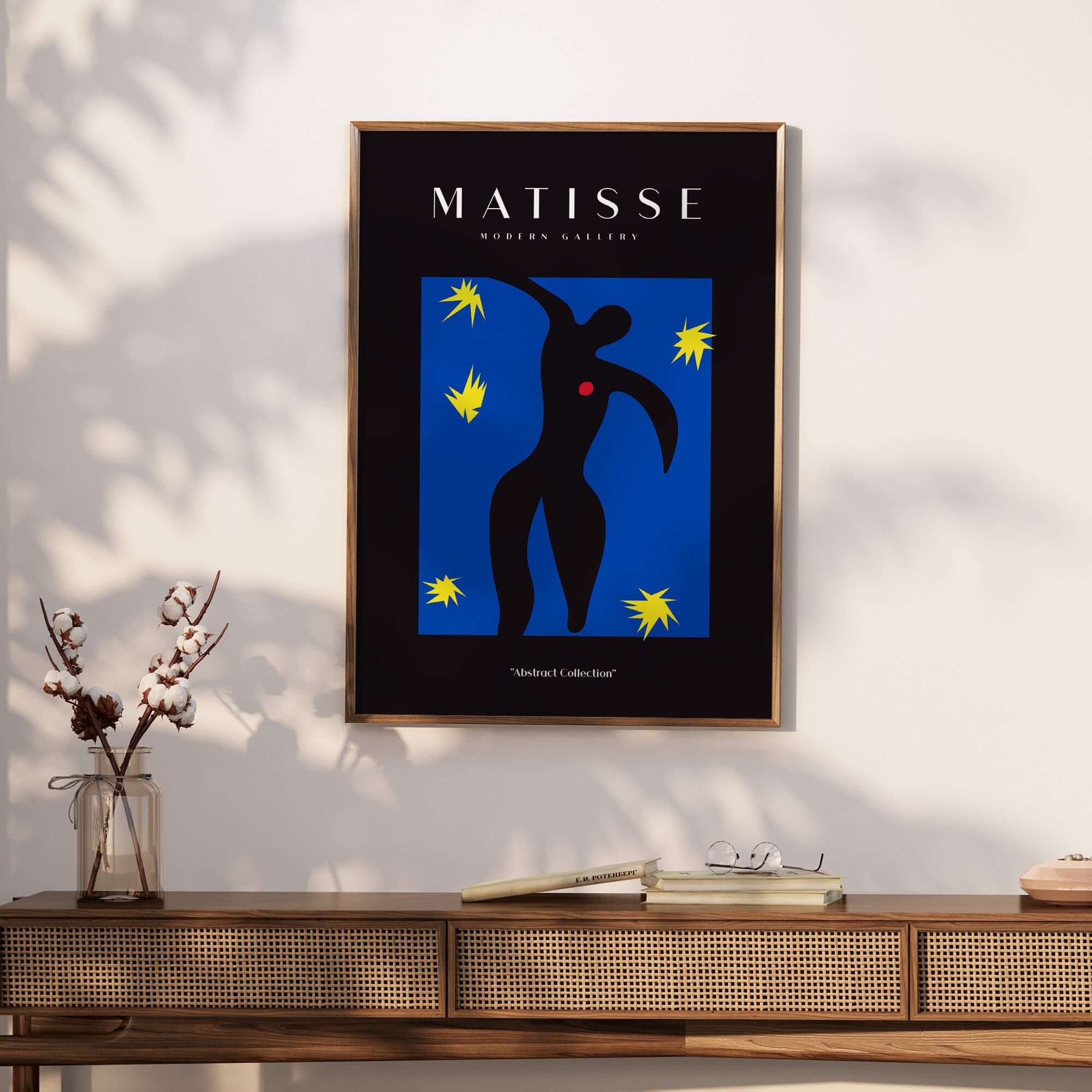 Matisse Art Prints - Icarus Black Figure with Stars Poster displayed on a wall with a modern wood console.