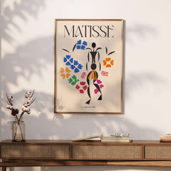 Matisse Art Print - La Négresse 1952 Poster featuring a black abstract figure and colorful floral shapes.