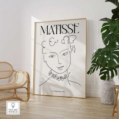 Matisse Art Print La Pompadour 1951 Minimalist Line Drawing Poster displayed in a modern interior with plants.