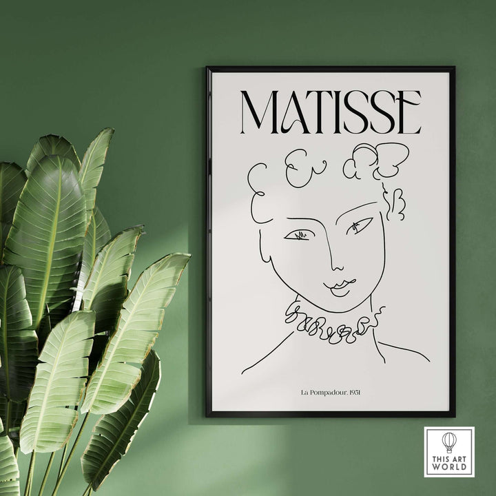 Matisse La Pompadour 1951 minimalist line drawing poster framed on a green wall with tropical plants.