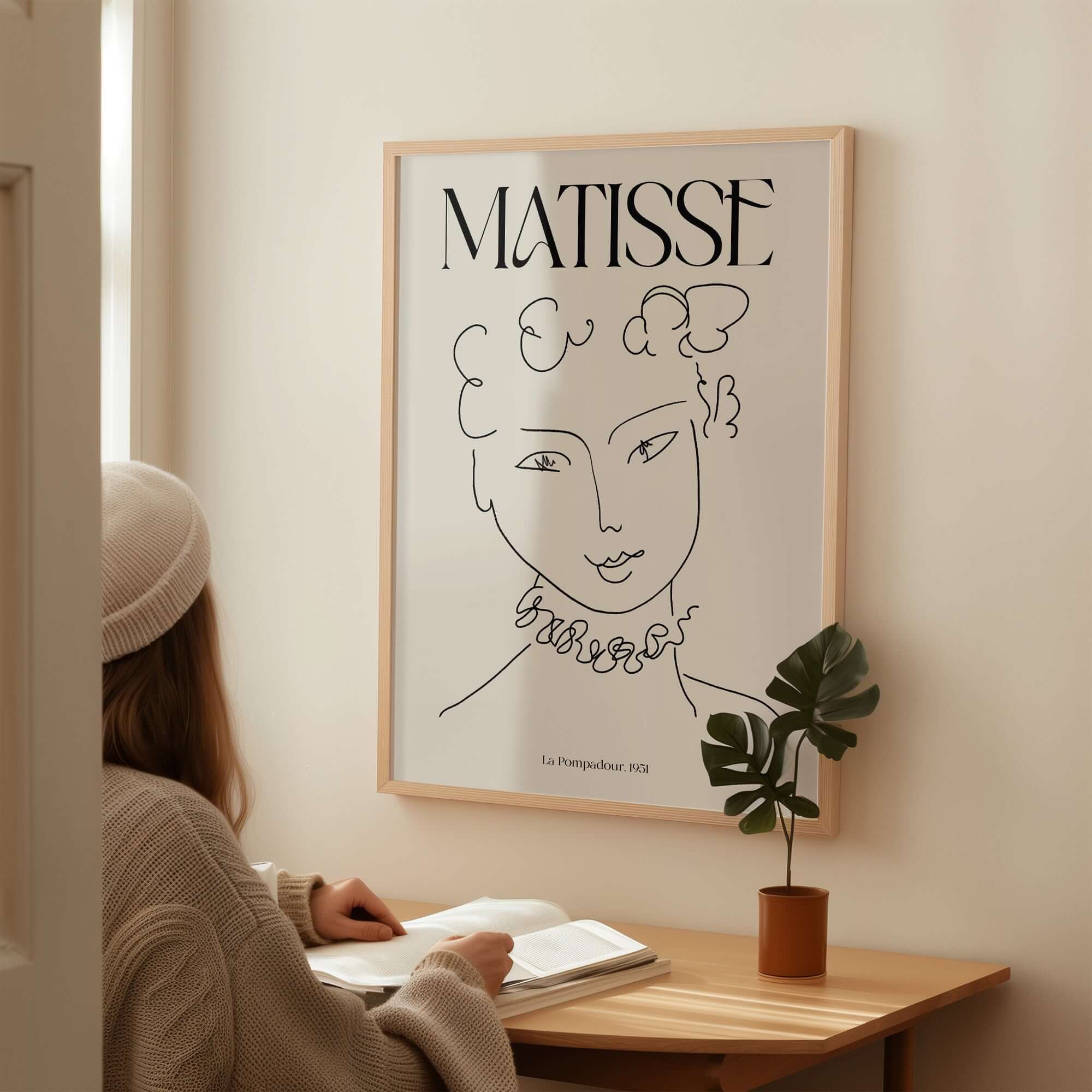 Matisse Art Print La Pompadour 1951 Minimalist Line Drawing Poster displayed on wall with person reading below.