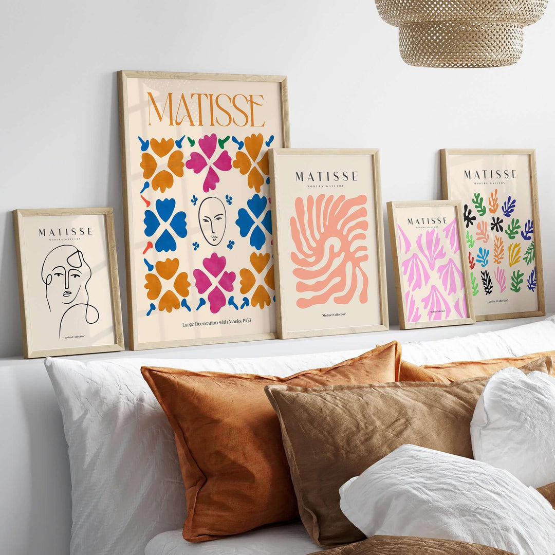 Matisse art prints displayed on a shelf, featuring masks, floral patterns, and vibrant colors in framed posters.