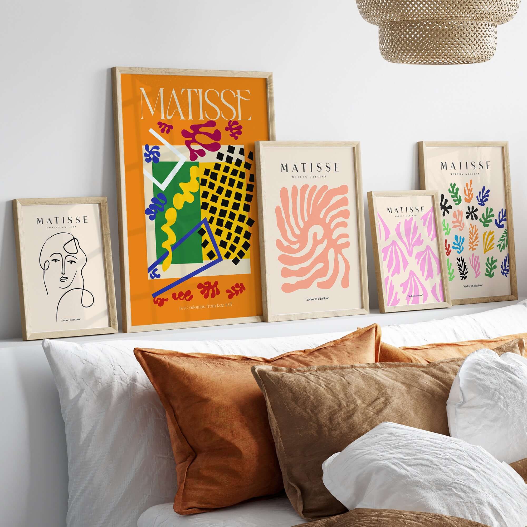 Matisse Art Print - Les Codomas Jazz 1947 Abstract Cut Out Art Poster displayed on wall with decorative pillows.