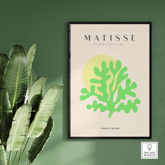 Matisse Art Prints - Lime Green Coral Abstract Sun Print displayed on a wall with green leaves background.
