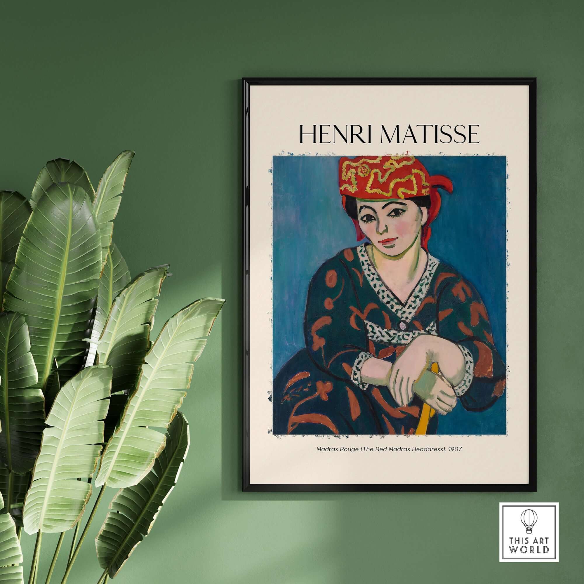 Matisse Art Print - Madras Rouge Red Headdress 1907 Wall Art Poster displayed against a green wall, featuring vibrant colors.