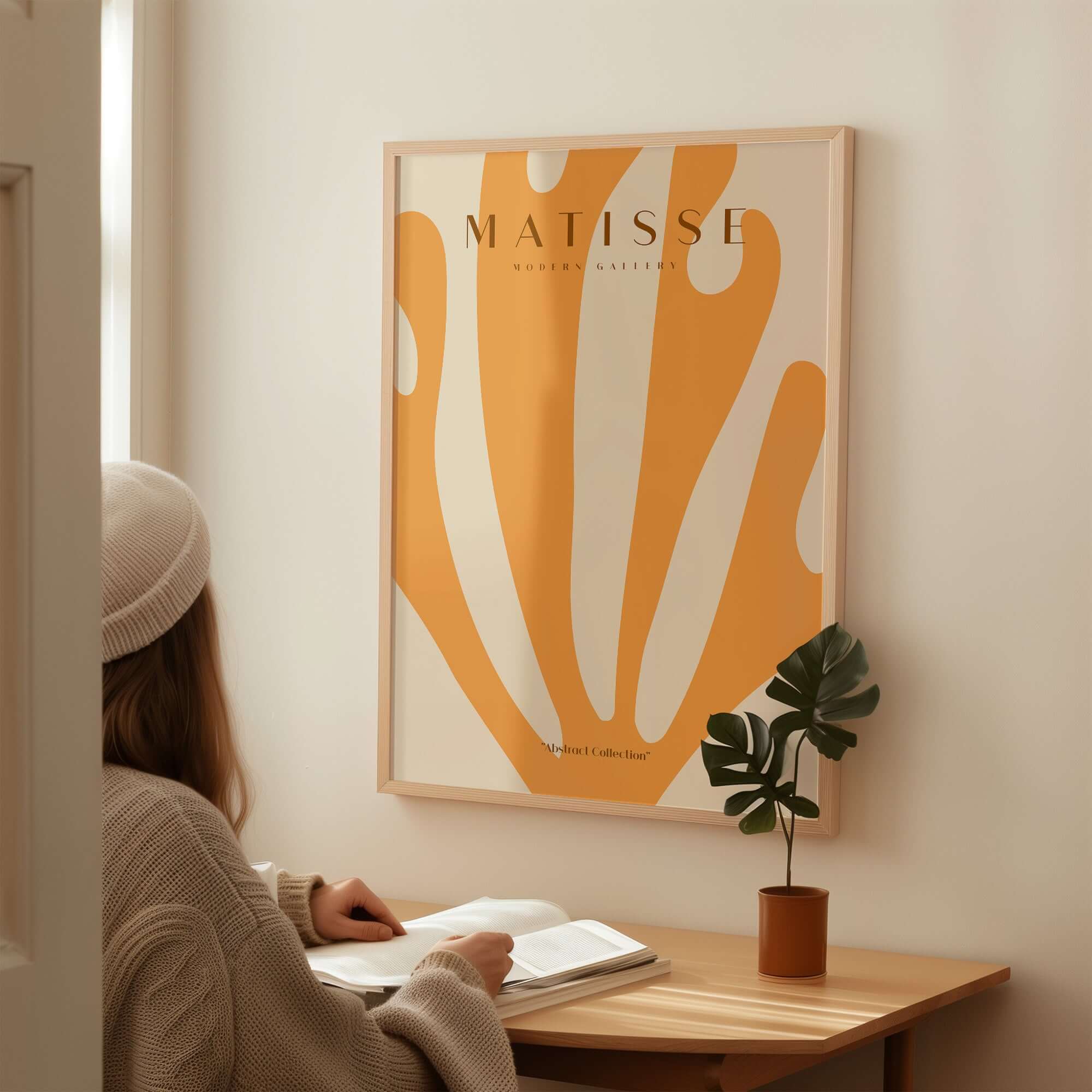 Matisse Art Prints -  Orange Fan Coral Abstract Shape Poster displayed on a wall with a woman reading nearby.