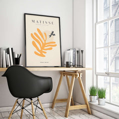 Matisse Art Prints - Orange Leaf Bird Silhouette Poster displayed in modern office with a black chair and plant decor.