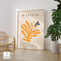 Matisse Art Prints - Orange Leaf Bird Silhouette Poster displayed in a modern interior setting with a plant.