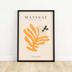 Matisse Art Prints - Orange Leaf Bird Silhouette Poster displayed in a modern frame on a light wood floor.