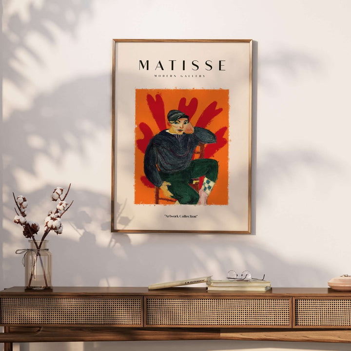 Matisse art print poster featuring a seated figure in a dark cap against an orange background with abstract shapes.