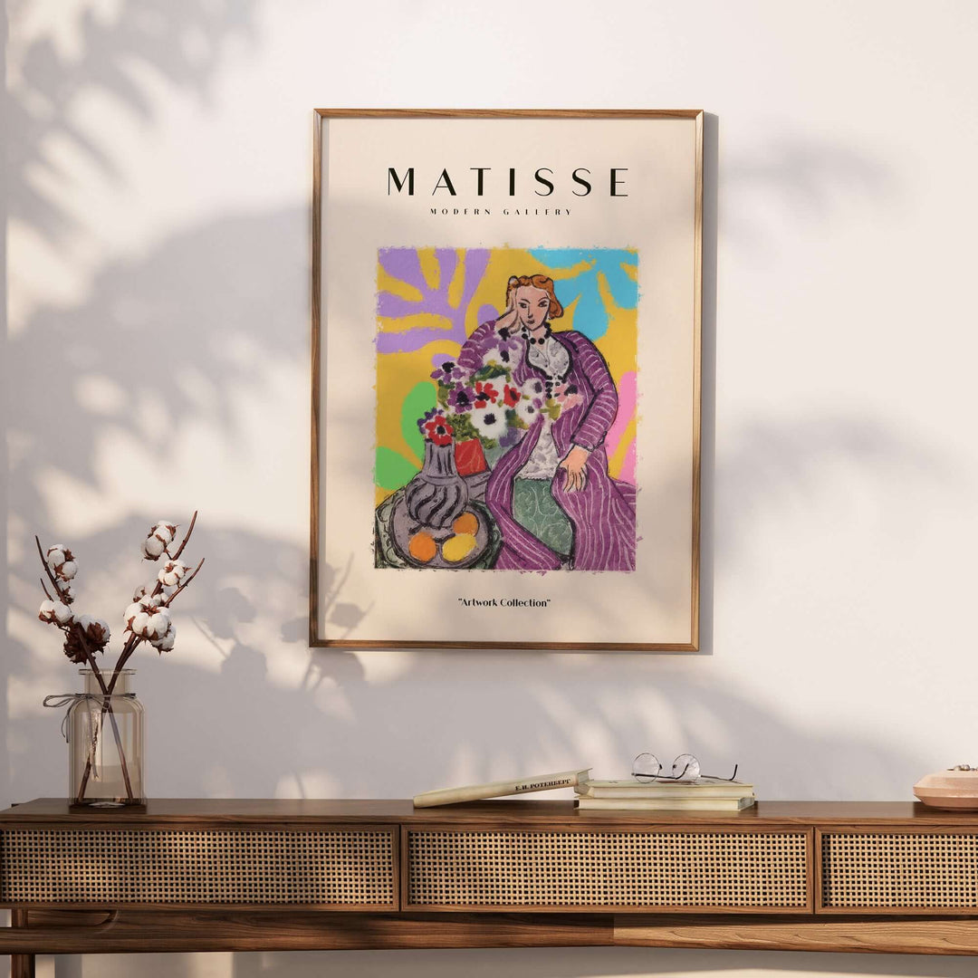 Matisse art print featuring a stylized woman in a purple robe beside a vase of flowers and fruit, vibrant abstract background.
