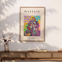 Matisse Art Prints - Stylized Woman with Flowers Fruit Still Life Interior Poster on a wall above a wooden table.