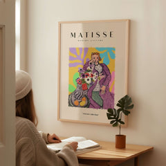 Matisse Art Prints - Stylized Woman with Flowers Fruit Still Life Interior Poster displayed on a wall in a cozy interior.