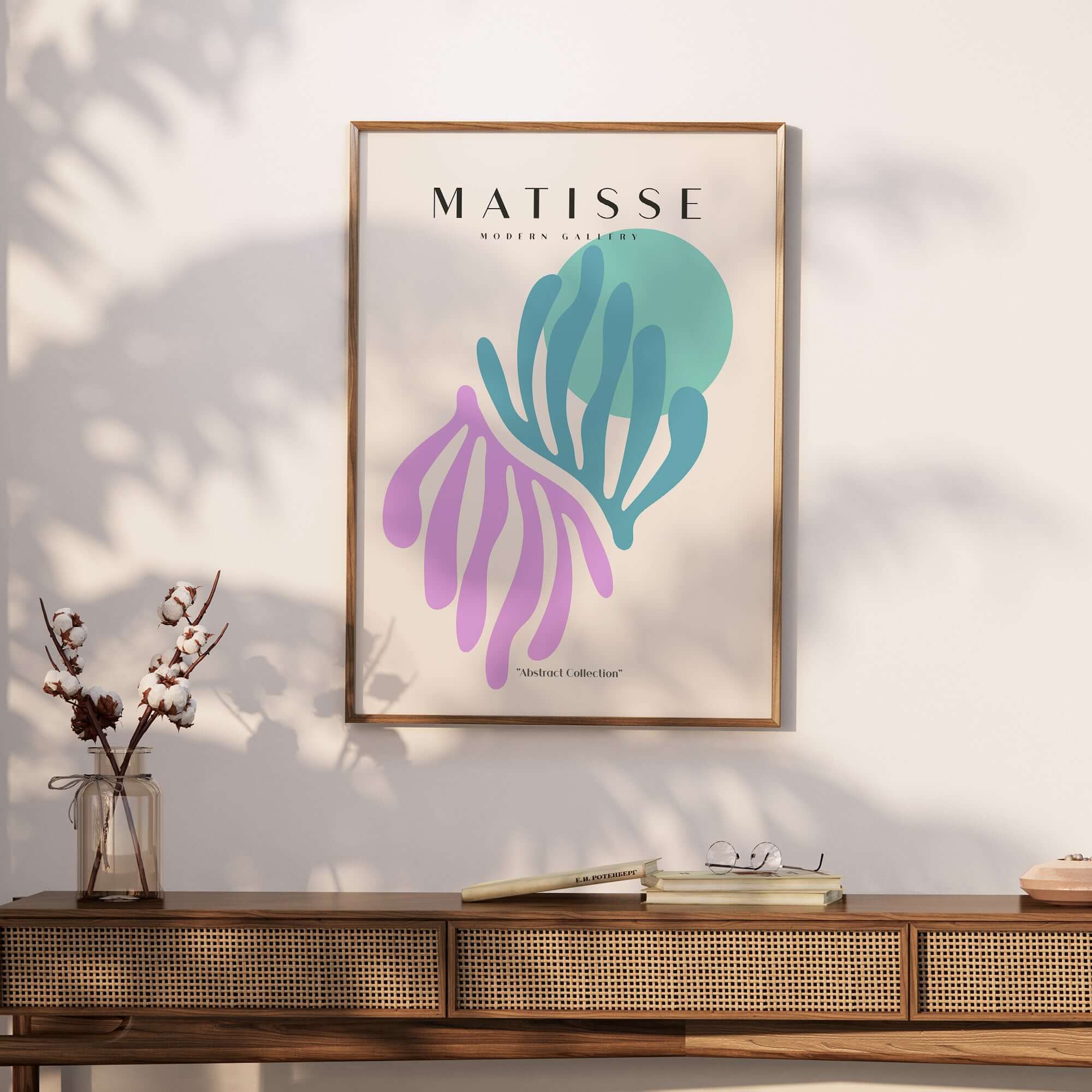 Matisse Art Prints -Teal Pink Abstract Leaves Sun Poster displayed on a wooden table with flowers and decor.
