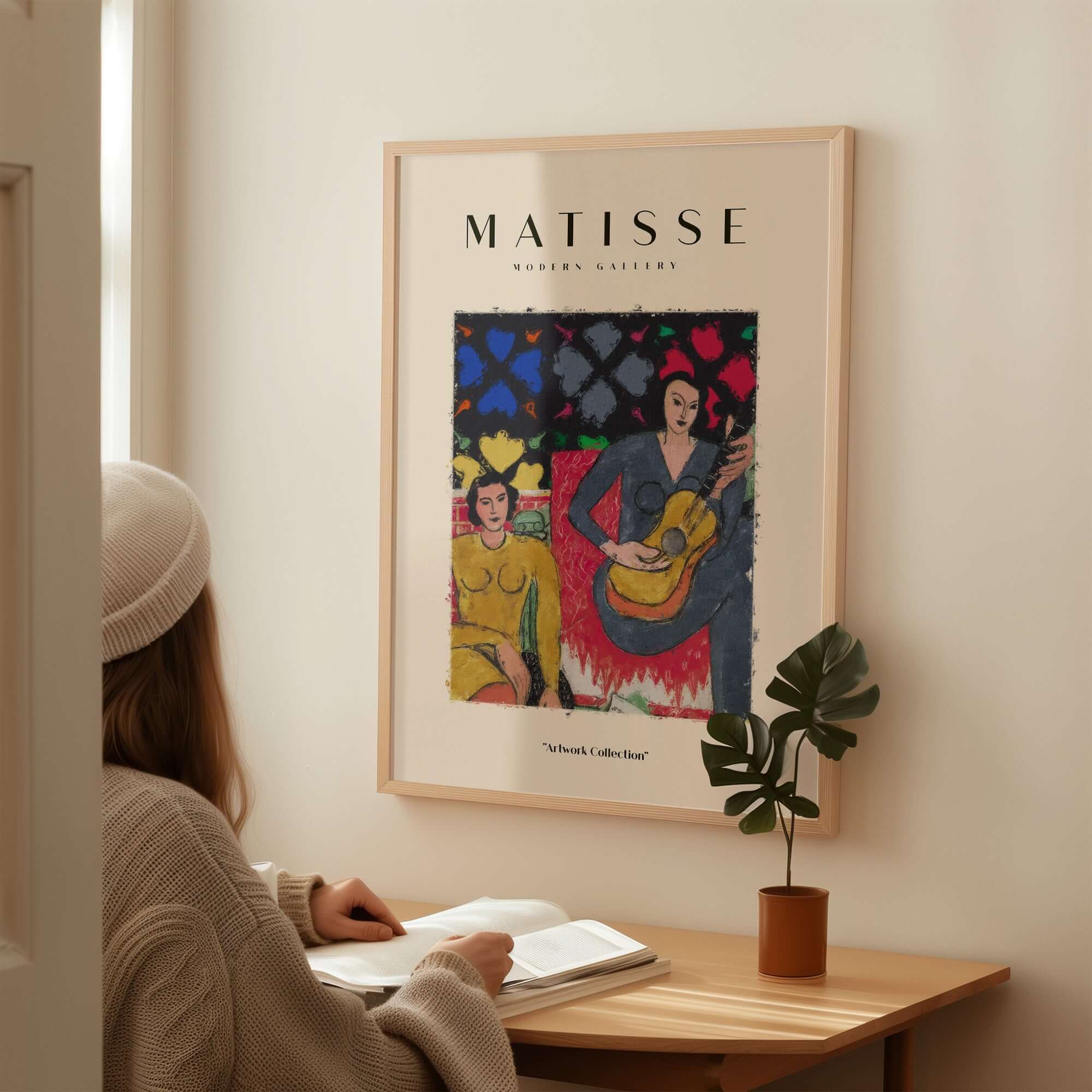 Matisse Art Prints - Two Women Guitar Interior Scene Poster displayed in a cozy setting with a woman reading nearby.