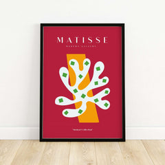 Matisse Art Prints - White Coral Abstract Green Diamonds Print displayed in a black frame on a wooden floor.