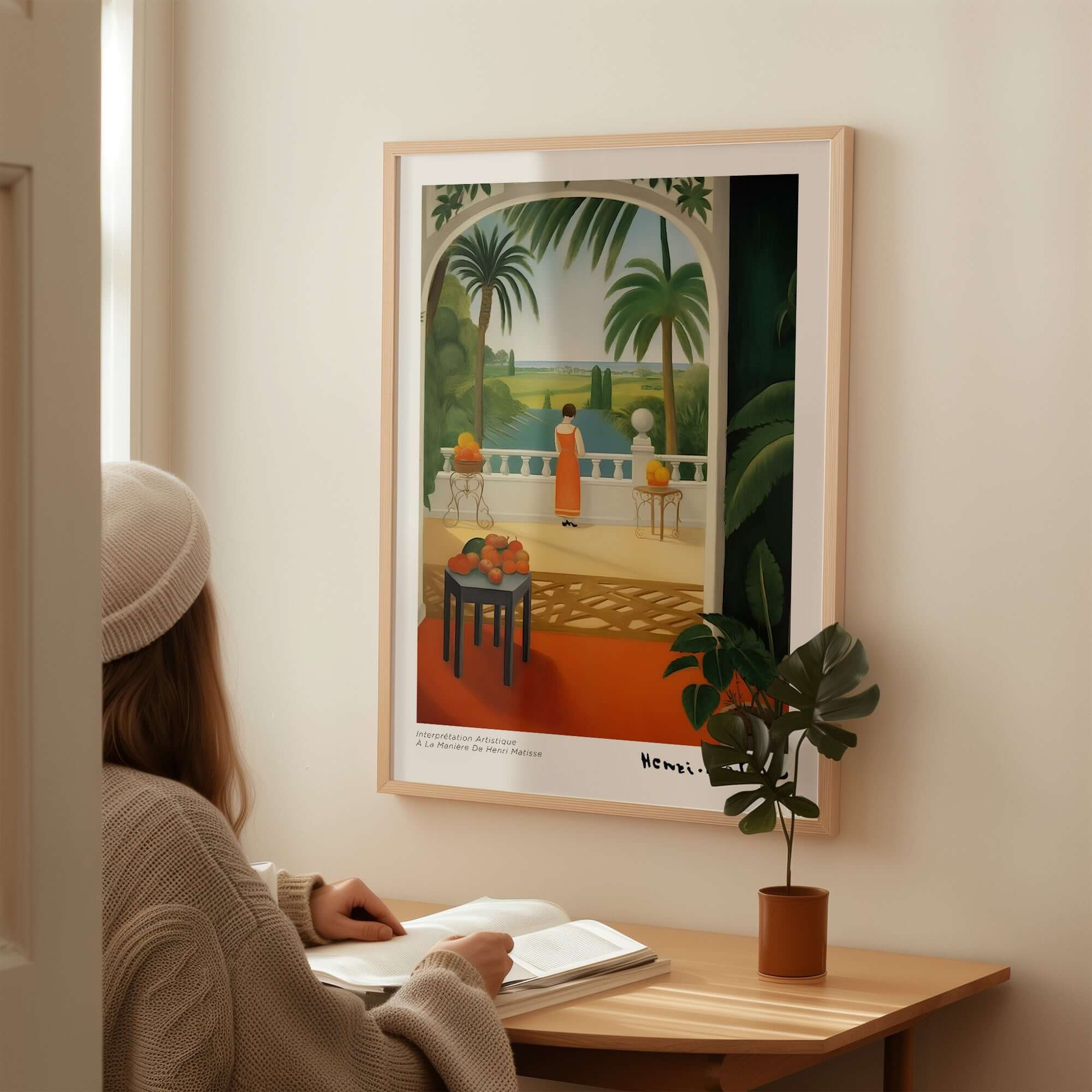 Matisse Art Prints - Woman on Balcony Sea View Poster displayed on wall with woman sitting at desk.