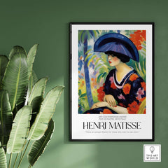 Matisse Art Prints - Woman with Blue Hat Garden Poster displayed in a modern interior setting with greenery.