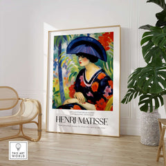 Matisse Art Prints - Woman with Blue Hat Garden Poster displayed in a stylish interior with plants and modern decor.