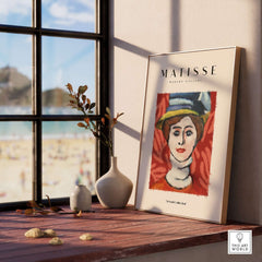 Matisse Art Prints - Woman in Elaborate Hat Portrait Poster displayed in a sunlit room with beach view