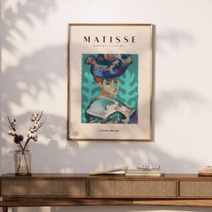 Matisse Art Prints - Woman Large Hat Portrait Teal Background Poster displayed in modern decor setting.