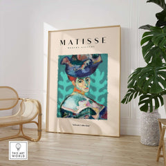 Matisse Art Prints - Woman Large Hat Portrait Teal Background Poster displayed in a stylish interior setting.