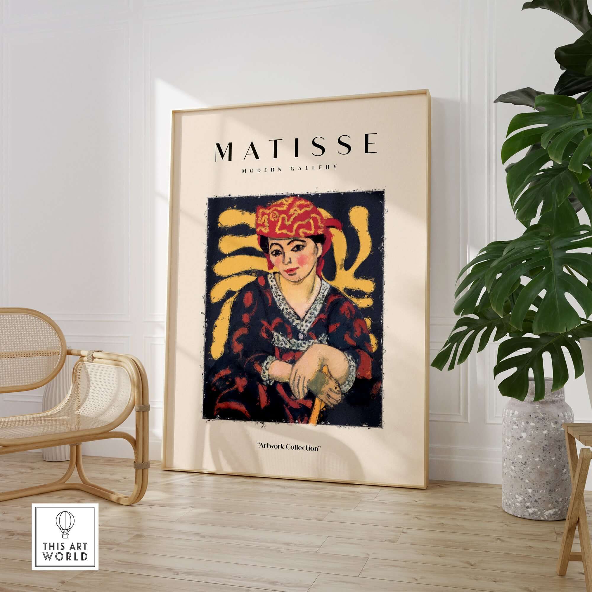 Matisse Art Prints -  Woman in Patterned Hat & Dress Poster displayed in a modern gallery setting with decorative plant.