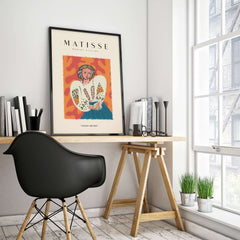Matisse Art Prints - Woman White Blouse Blue Skirt Portrait Poster displayed in a stylish interior with desk and plants.