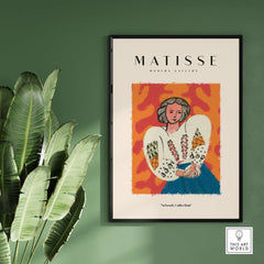 Matisse Art Prints - Woman White Blouse Blue Skirt Portrait Poster displayed in a modern gallery setting with foliage.
