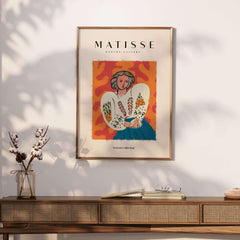 Matisse Art Prints - Woman White Blouse Blue Skirt Portrait Poster displayed on a wall with decorative furniture.
