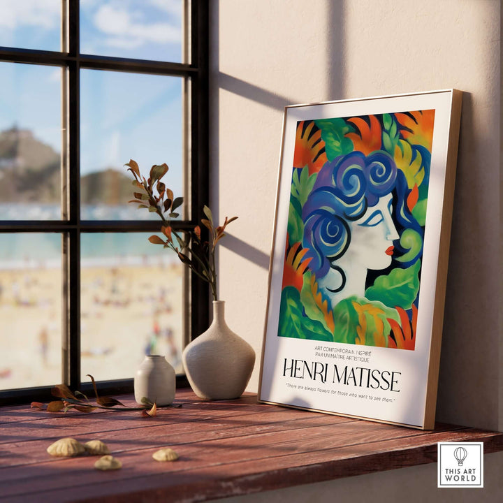 Henri Matisse art print featuring a woman's face with blue hair and vibrant flowers, displayed on a windowsill.