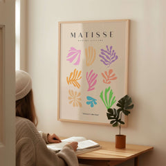Matisse Art Prints - Abstract Botanical Shapes Grid Poster displaying colorful shapes on beige background in a cozy setting.