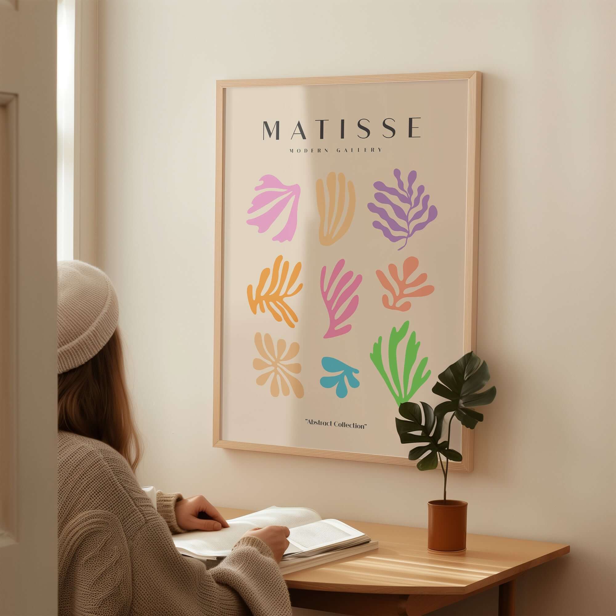 Matisse Art Prints - Abstract Botanical Shapes Grid Poster displaying colorful shapes on beige background in a cozy setting.