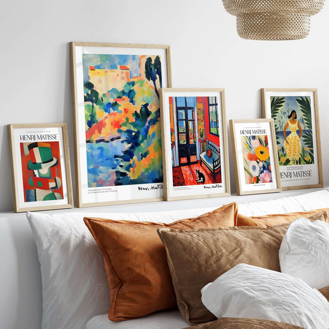 Collection of Matisse art prints displayed on a sofa, featuring vibrant abstract designs and bold colors.