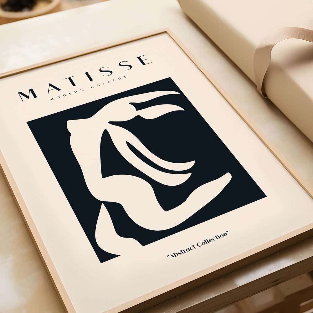 Matisse Art Prints - Abstract Organic Figure Cut Out Print displayed in a frame on a table, showcasing minimalist design.